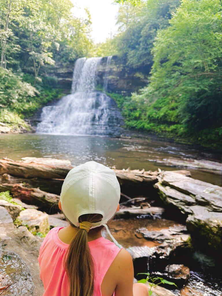 Little girl looking at waterfall